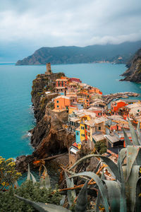 High angle view of townscape by sea against sky