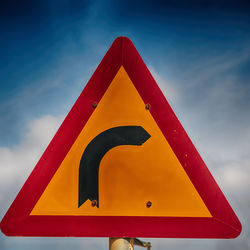 Low angle view of road sign against sky