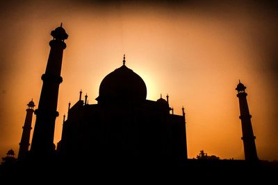 Silhouette cathedral against sky during sunset