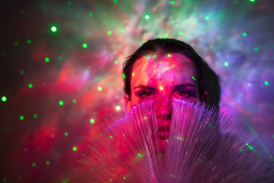 Portrait of woman with pink light painting at night