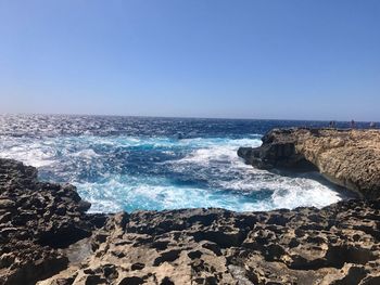 Scenic view of sea against clear blue sky