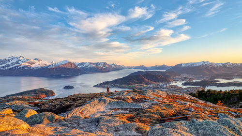 Scenic view of mountains and river against sky during sunset