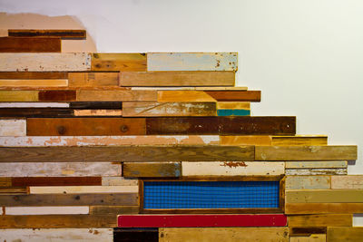 Close-up of stacked wood against white background