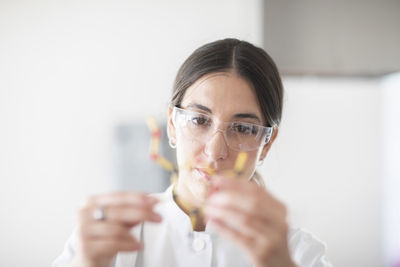 Scientist female with lab glasses, tablet and sample in a lab