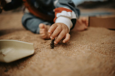 Baby playing with toys in the sand on the beach