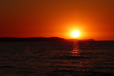 Scenic view of sea against orange sky during sunset