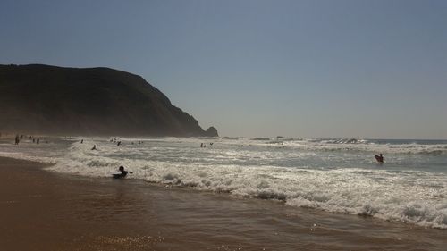 Scenic view of beach against clear sky