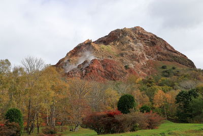 Low angle view of mountain against sky during autumn