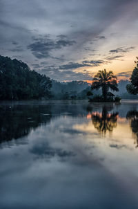 Scenic view of lake against sky at sunset