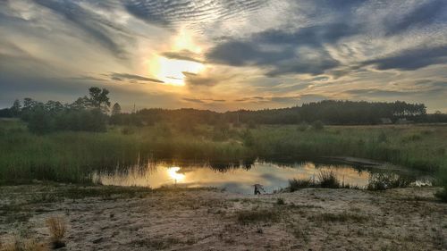 Scenic view of lake against sky during sunset