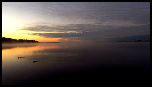 Scenic view of sea at sunset