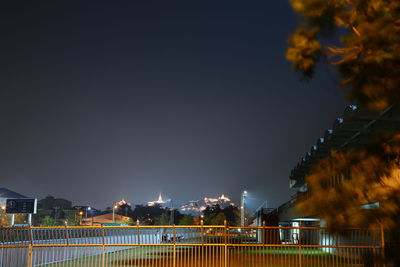 Low angle view of illuminated buildings against sky at night