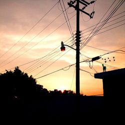 Low angle view of electricity pylon against sky