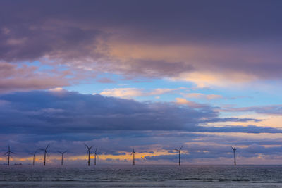 Scenic view of field against sky during sunset