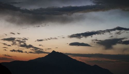 Scenic view of silhouette mountains against sky at sunset