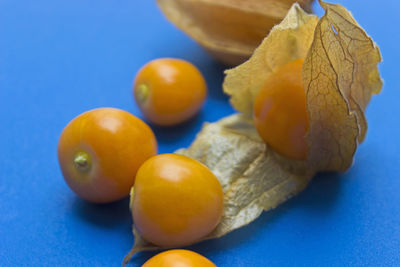 Close-up of fruits on blue table