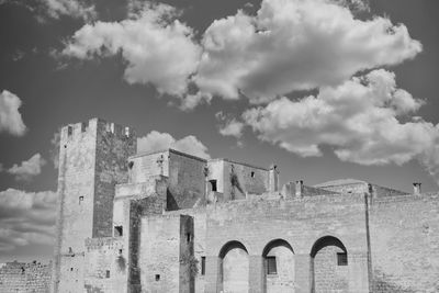 Low angle view of old ruins against cloudy sky