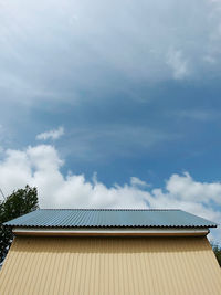 Low angle view of building roof against sky