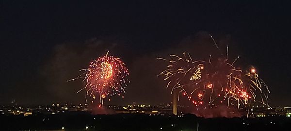 Low angle view of firework display at night