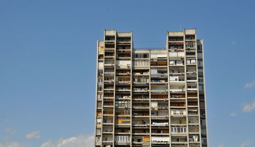 Low angle view of buildings against clear blue sky