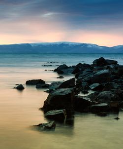 Scenic view of sea against sky at sunset