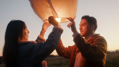 Boy and girl couple are preparing the chinese lantern