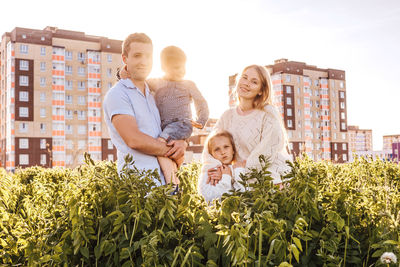 Group of people against plants