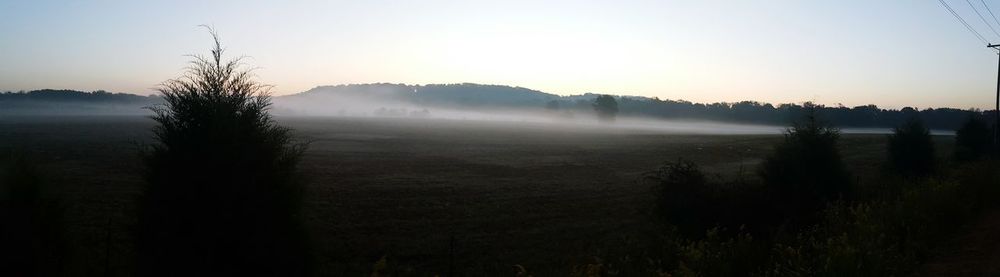 Scenic view of field against sky during sunrise