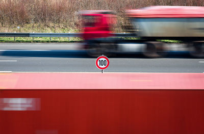 Speed limit sign on highway railing