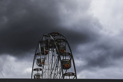 Low angle view of ferris wheel against sky