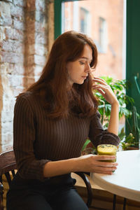 Woman having drink in cafe