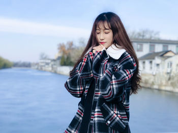 Portrait of a beautiful young woman standing outdoors