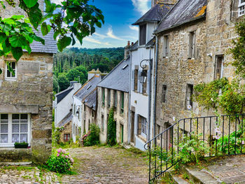 Houses in village amidst buildings in town