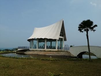 Built structure by sea against sky