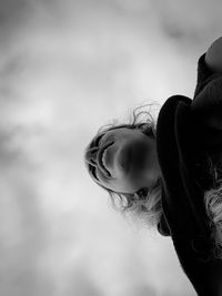 Close-up portrait of woman against sky