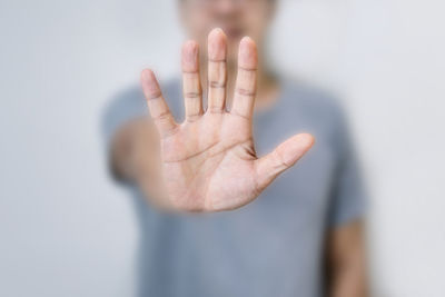 Midsection of man showing stop sign