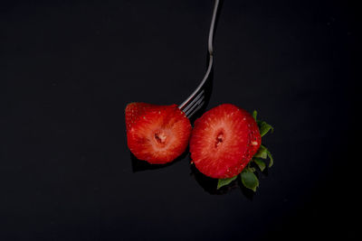 Close-up of strawberry over black background