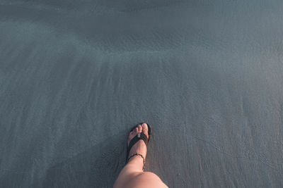 Low section of woman standing on ground