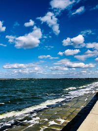 Scenic view of sea against blue sky