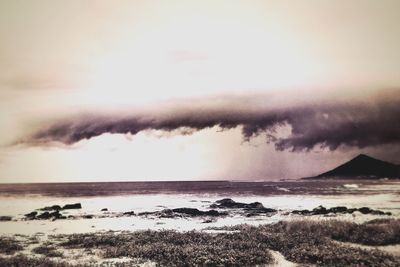 Scenic view of sea against cloudy sky