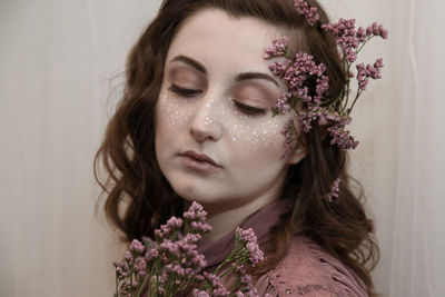 Close-up of woman with purple flowers