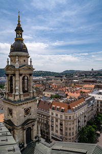 Aerial view of buildings in city against sky