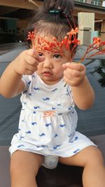 Portrait of cute girl holding hands