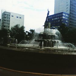 Buildings in city against sky