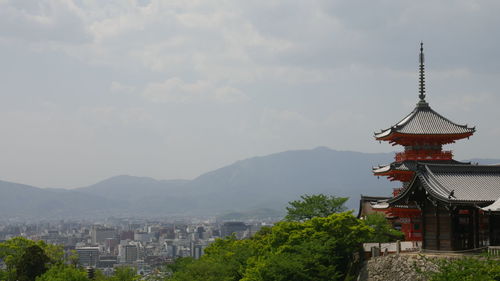 Buildings against cloudy sky