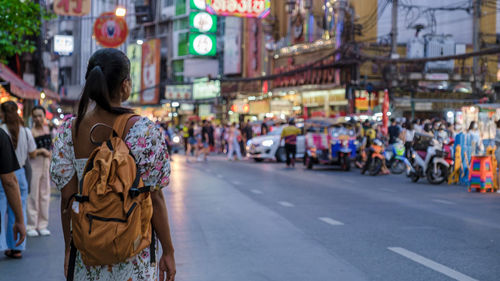 Rear view of woman walking on street