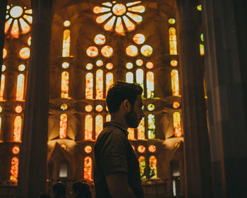 Full length of man standing in illuminated building