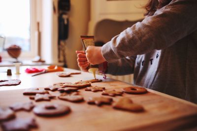 Close-up of person preparing food on table at home