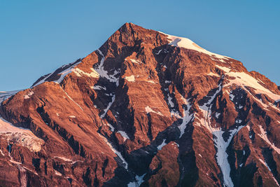 Low angle view of rocky mountain against sky