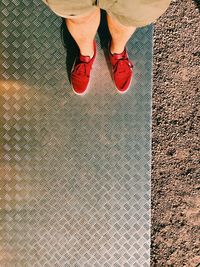 Low section of woman standing on tiled floor